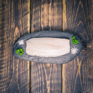 Cod loin fillet on a slate background