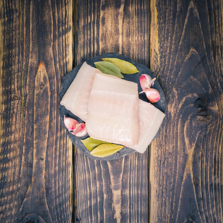 Halibut fillets on a slate background