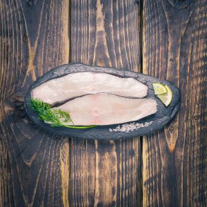 Halibut steaks on a slate background