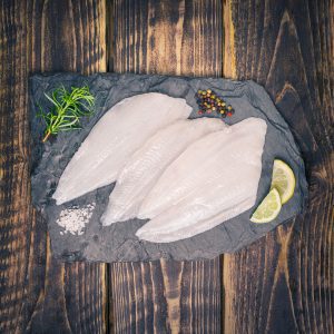 lemon sole fillets on a slate background