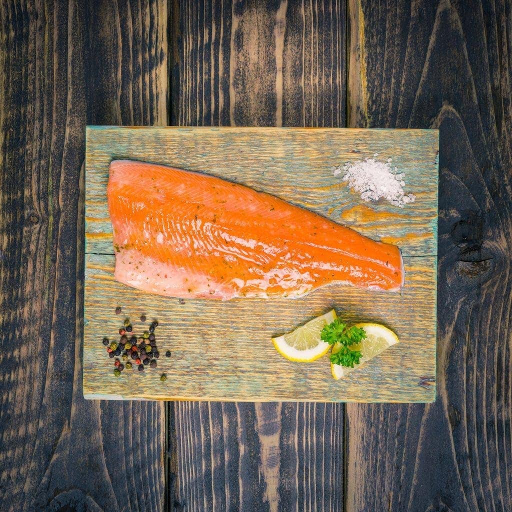lemon and coriander trout fillet on a chopping board