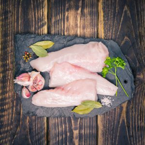 Monkfish fillets on a slate background