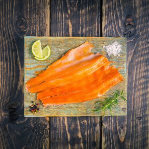 Smoked trout fillets on a chopping board