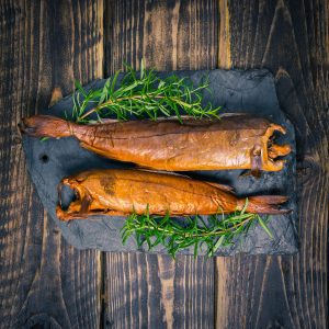 Two Arbroath smokies on a slate background