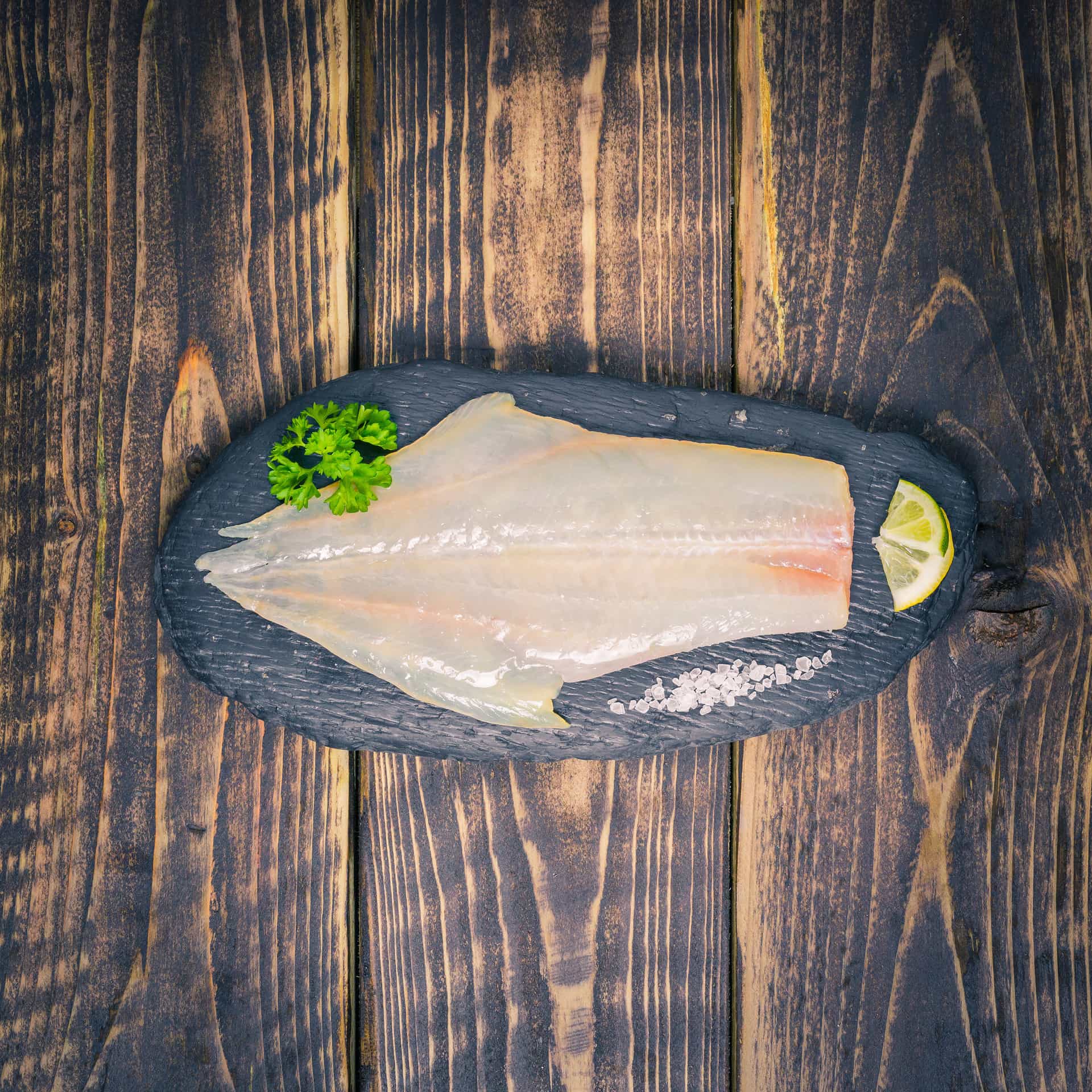 Peat smoked haddock fillet on a slate background