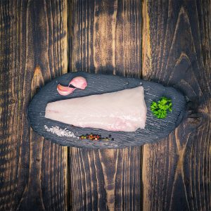 monkfish fillet on a slate background