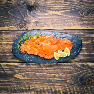 Smoked salmon trimmings on a slate background