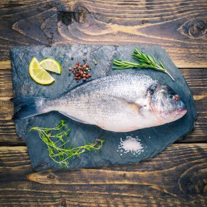 Whole sea bream on a slate background