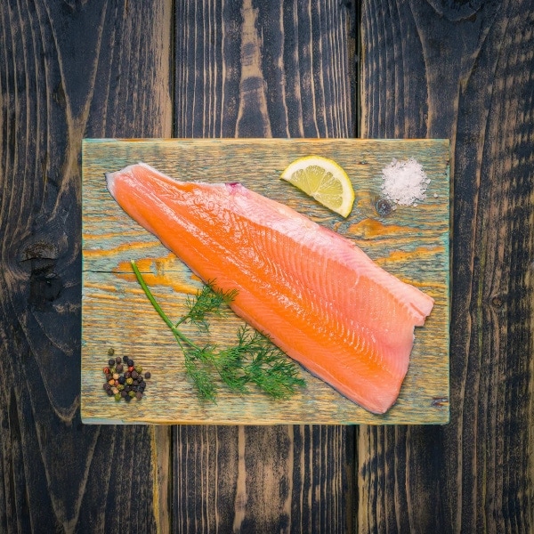 Trout fillet on a wooden chopping board