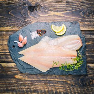 Peat-smoked haddock fillets on a slate background