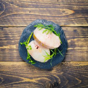 two cod steaks on a piece of slate