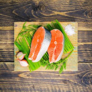 two salmon steaks on a bed of chives