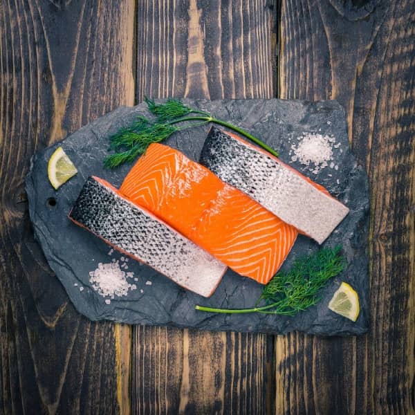 Salmon fillets on a slate background