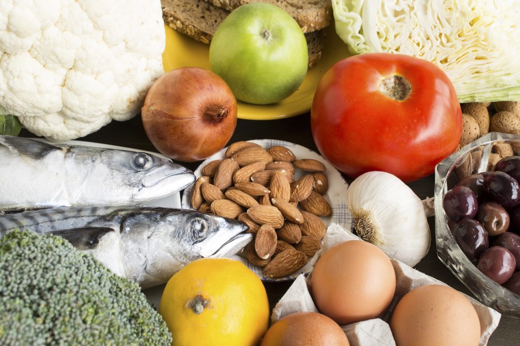 A selection of food recommended for diabetes, including almonds, fish, eggs, fruit and broccoli